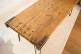 Reclaimed industrial coffee table top, highlighting rustic wood grain, rich patina, and metal accents.