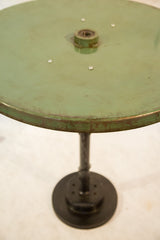 Reclaimed light green tabletop showing industrial wear and distressed edge.