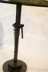 Dark industrial metal base of the bistro table with threaded post and adjustment chain.