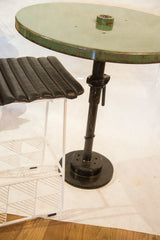 Heavy black circular base and adjustable column of the industrial bistro table.