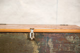 Industrial trunk with rustic metal latch and textured, distressed multi-color paint.