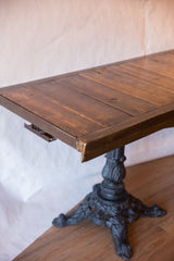 Corner detail of the reclaimed wood buffet table showing the ornate vintage iron base.
