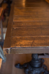 Corner detail of the reclaimed wood top showing its warm tones and iron framing.
