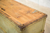 Distressed light green industrial cart lid with natural wood and metal accents.