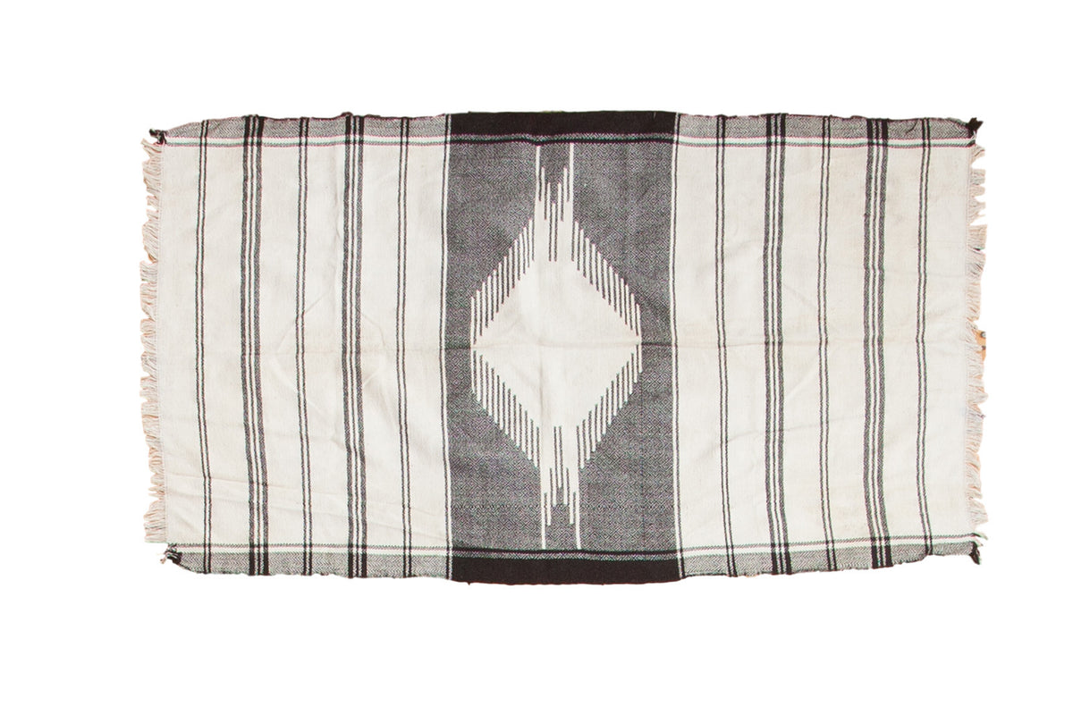 Vintage Kurdish throw rug featuring ivory and black stripes and an elongated geometric medallion.