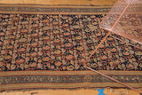 Hamadan rug detail: allover boteh paisley lattice, navy, terra cotta hues, and visible foundation wear.