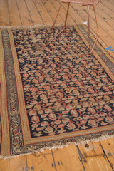 Tattered fringe, traditional Hamadan rug border, and dark boteh design.