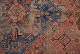 Antique Hamadan rug close-up showing intricate floral and pinwheel motifs amidst time-softened texture.