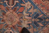 Antique Persian Hamadan rug with a distressed hole, surrounded by sky blue, blush, and bronze florals.