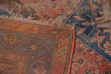 Tattered edge and distressed red, blue, bronze pile of antique Hamadan rug.