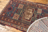 Antique Fachralo Kazak rug displaying geometric rams horn motifs in brick red, teal, and beige.