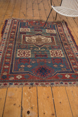 Tattered fringe and distressed geometric border of an Antique Fachralo Kazak rug.