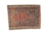 Persian Hamadan rug fragment with tangerine diamond medallion and blue Herati motif.
