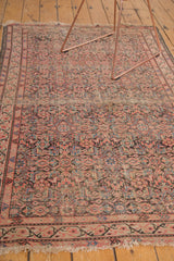 Tattered fringe and distressed allover Herati design on an antique Malayer rug.