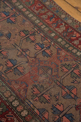 Distressed pile of vintage Kurdish Hamadan rug with geometric tree of life and colorful leaves.