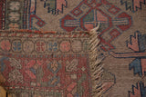 Detail of vintage Kurdish Hamadan rug: geometric pattern, distressed pile, and woven foundation.