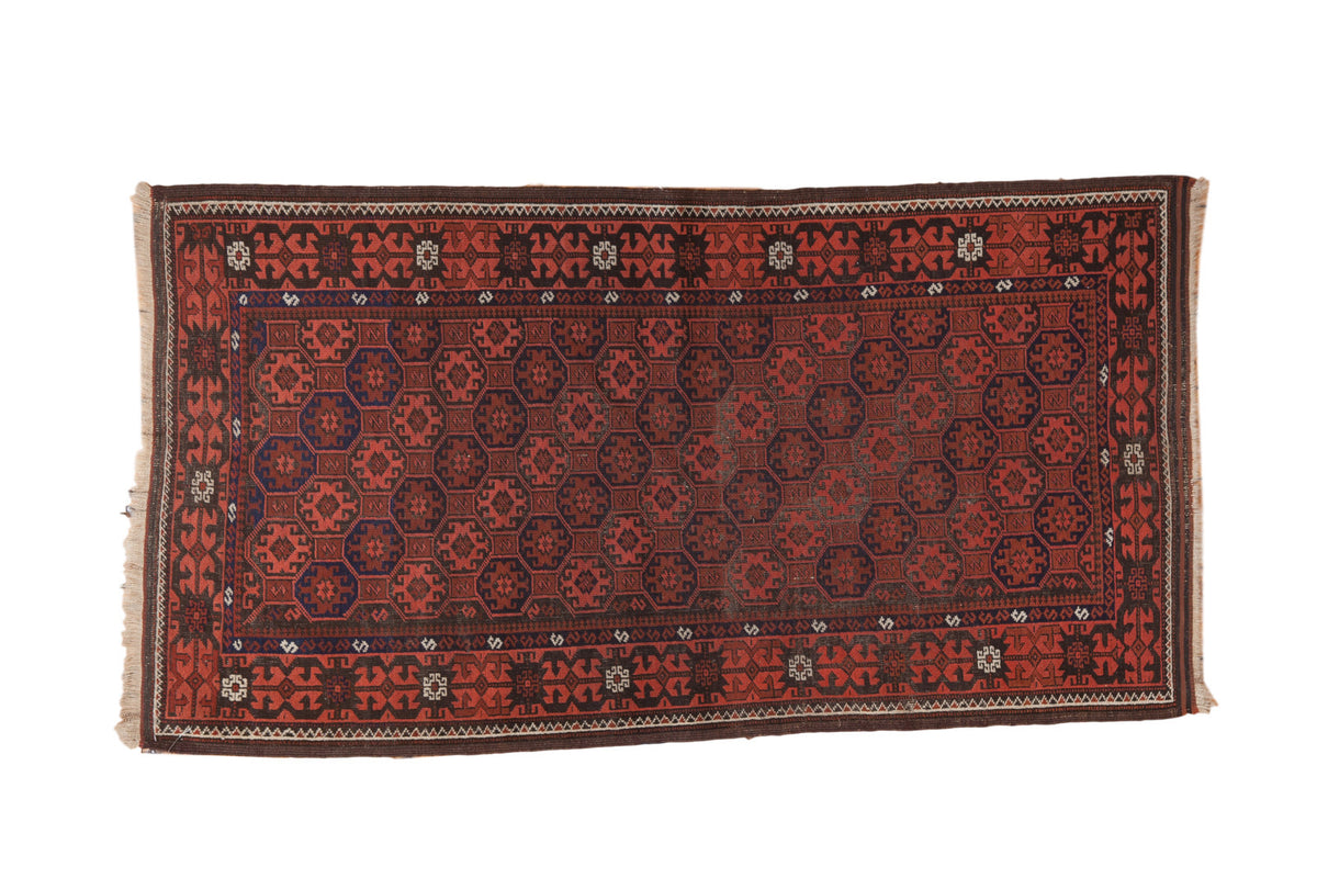 Vintage Afghan rug with repeating gul motif, lattice pattern, crab border, brick red, charcoal, and navy.