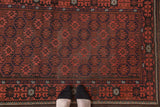 Tribal Afghan rug's brick red gul motif, navy accents, and intricate crab border.