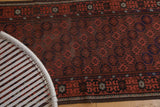 Detail of hand knotted Afghan rug showing goat hair selvages and time-softened crab border.