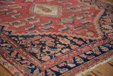 Distressed cinnabar red field and intricate charcoal blue border detail.