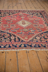 Distressed dark border and cream fringe on a vintage Persian Malayer rug.