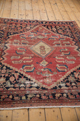 Distressed cinnabar red field with localized foundation showing through Malayer Herati motif.