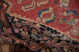 Cinnabar red, charcoal black distressed pile of vintage Malayer rug with visible foundation.