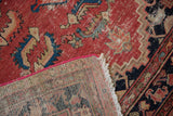 Malayer rug with exposed foundation, bright pink-secured side, and distressed cinnabar red pile.