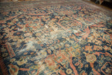 Antique Mustafi Mahal rug showing intricate floral motifs, deep blue, terra cotta, and foundation wear.