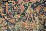 Antique Mustafi Mahal carpet detail: intricate floral patterns on indigo ground with visible foundation wear.