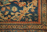 Mustafi Mahal carpet corner: deep blue ground, terra cotta floral roundels, intricate border.