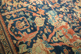 Antique Mustafi Mahal carpet, intricate floral roundels in indigo, terra cotta, ivory, showing wear.