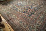 Antique Mustafi Mahal rug corner with intricate borders and curvilinear florals in indigo, peach, and ivory.