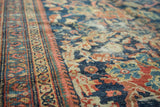Antique Mustafi Mahal rug border and field detail: deep blues, terra cotta, ivory, intricate florals, localized wear.