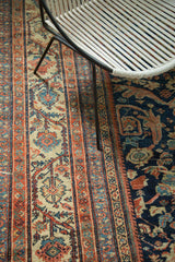 Antique Mustafi Mahal rug detail: geometric stripes and a dark blue curvilinear floral field.