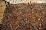 Antique Qashqai rug's madder red, indigo, gold hook and latch pattern, with even wear.