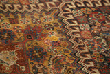 Antique Qashqai rug close-up: intricate hook and latch motif, madder red, saffron gold, and wear.