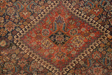 Intricate geometric patterns with madder red and indigo fields on an antique Qashqai rug.
