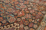 Rich madder, indigo, and saffron gold palette of intricately woven Qashqai motifs.