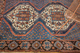 Vintage Afshar rug: geometric medallion, indigo field with rust boteh, tribal border.