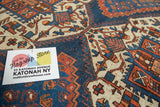 Hand-knotted Afshar rug with blue field, contrasting terra cotta and beige rectilinear motifs.
