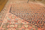 Blush and indigo Herati motif meets the contrasting inner border of an antique Malayer rug.