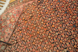 Antique Persian Malayer rug with blush and indigo Herati pattern, tangerine accents, and even pile wear.