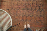 Exaggerated paisley boteh and distressed madder red pile on antique Afshar tribal rug.