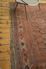 Antique Afshar carpet's tattered kilim, showing geometric blue border and distressed pile.