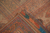 Distressed red and blue paisley field with visible woven foundation of antique Afshar rug.
