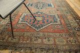 Rectilinear medallion, pomegranate border, and tattered fringe on an antique Persian Soumac rug.