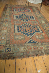 Lower border of the antique Persian Soumac carpet, showing geometric motifs and tattered ends.