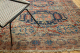Antique Soumac rug's geometric red and navy pattern with visible foundation and frayed edge.