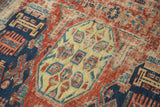 Flat-woven antique Soumac rug detail featuring geometric red, navy blue, and pale yellow motifs.